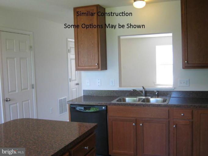 72 Baltic Lane Ranson, WV 25438 - Photo 6 of 17 a kitchen with a sink refrigerator and cabinets