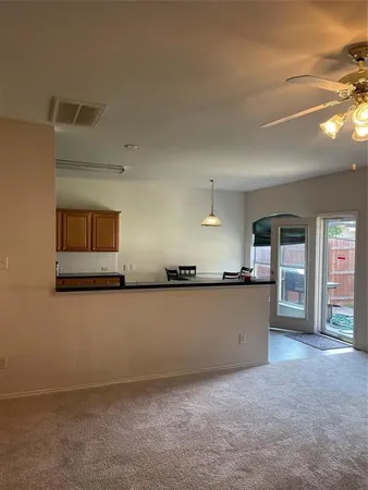 a view of an empty room with a kitchen