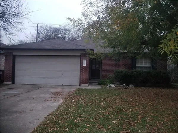 a front view of house with yard and trees