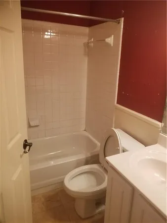 a bathroom with a shower and a toilet