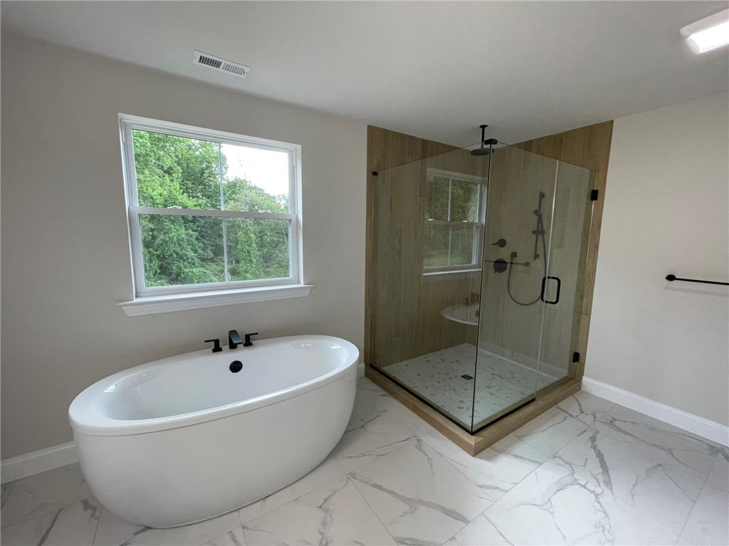 5043 Chapmans Road Orefield, PA 18069 - Photo 20 of 30 Unwind in a luxurious free-standing soaking tub or refresh in the spacious glass-enclosed shower.