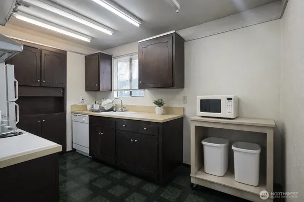 a kitchen with a sink cabinets and appliances