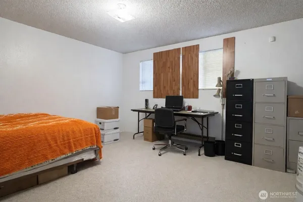 a bedroom with a bed and a desk