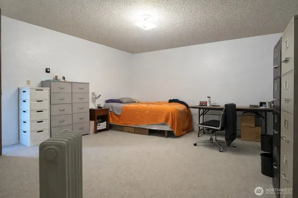 a bedroom with furniture and a window