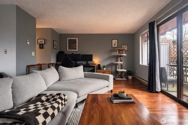 a living room with furniture and wooden floor