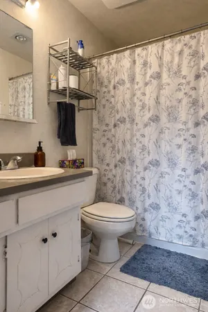 a bathroom with a toilet sink and mirror