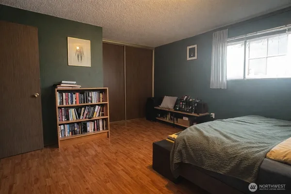 a bedroom with a bed and a book shelf