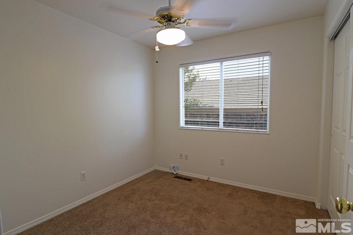4652 Goodwin Road Sparks, NV 89436 - Photo 14 of 20 an empty room with a window and a fan