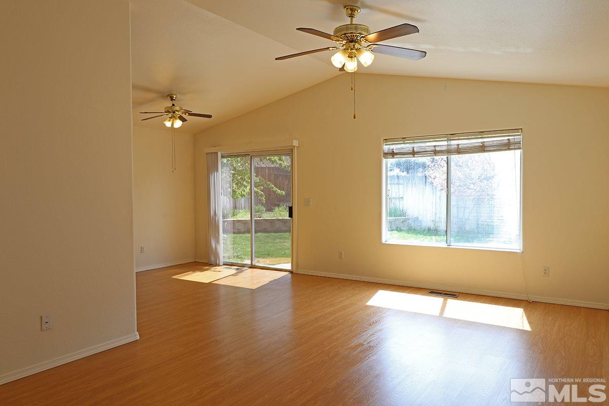 4652 Goodwin Road Sparks, NV 89436 - Photo 4 of 20 a view of an empty room with a window and wooden floor