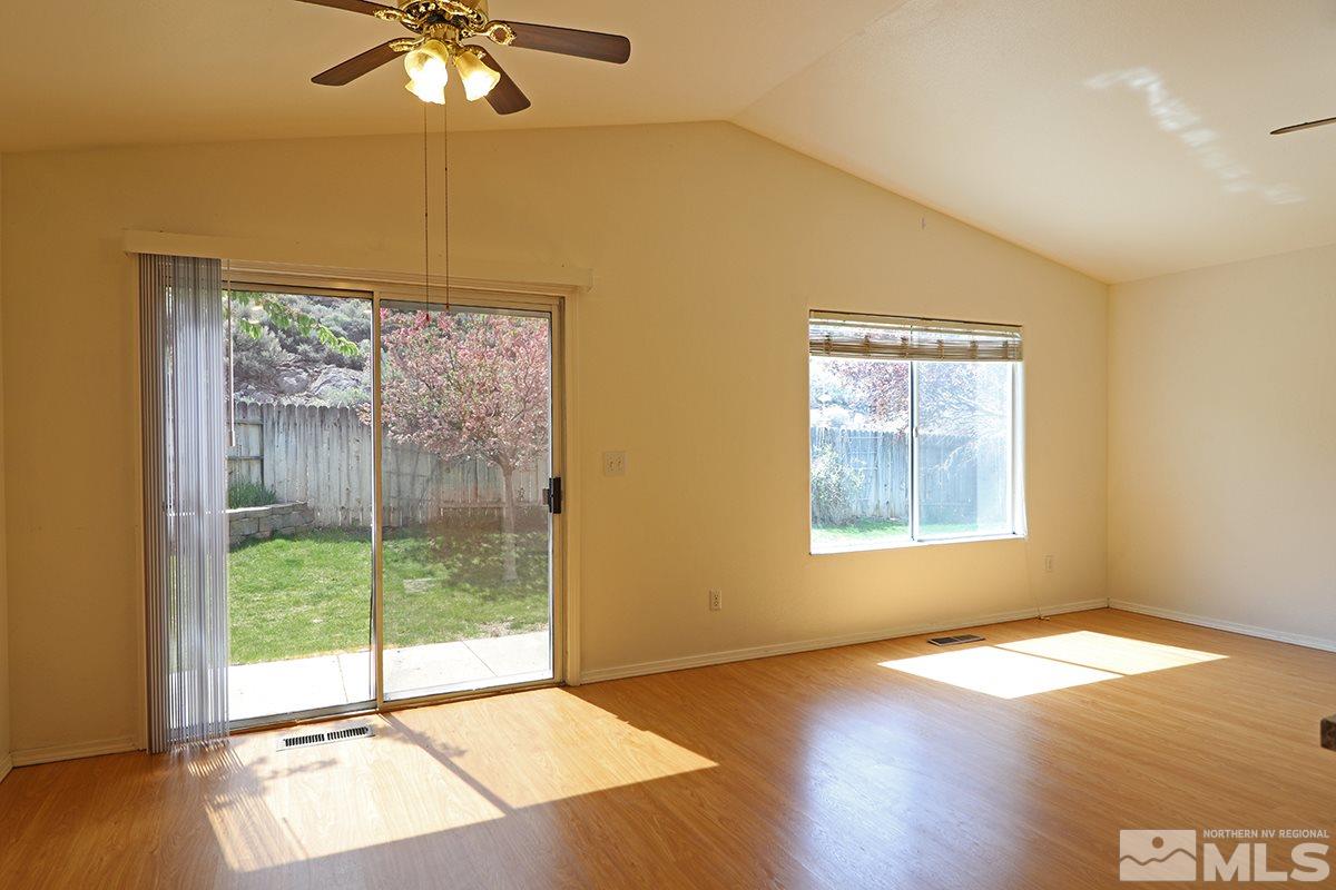 4652 Goodwin Road Sparks, NV 89436 - Photo 6 of 20 a view of an empty room with wooden floor and a window