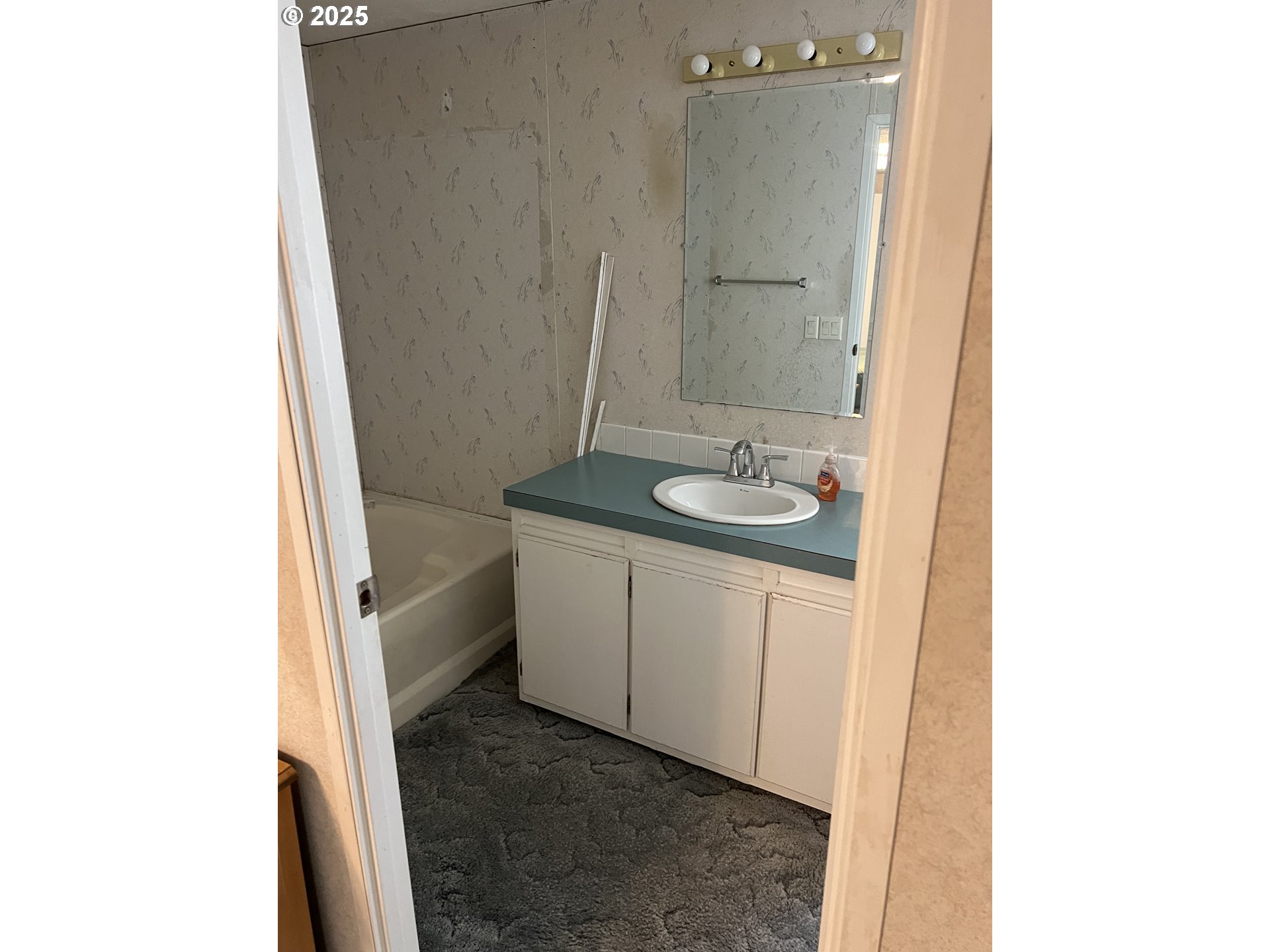 2801 Southwest Hautama Road Pendleton, OR 97801 - Photo 7 of 11 a bathroom with a granite countertop sink and a mirror