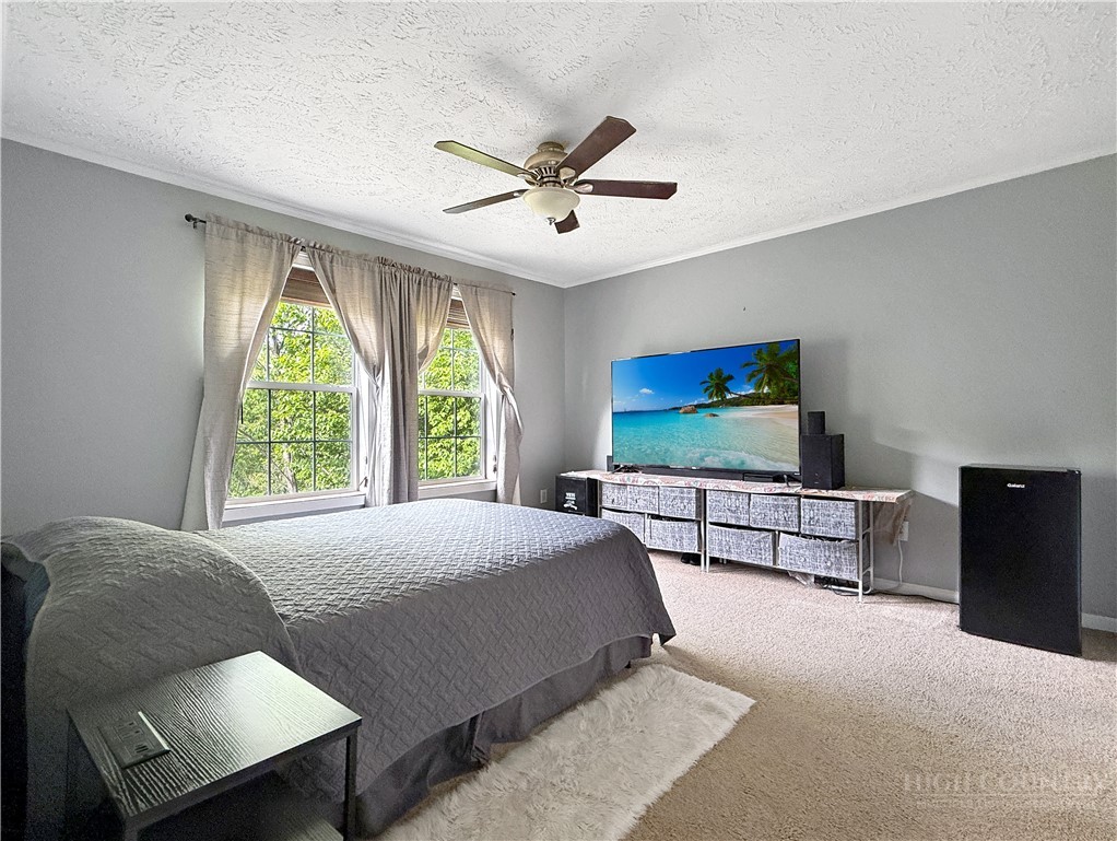 1173 Hopewell Church Road Boone, NC 28607 - Photo 12 of 39 a bedroom with a bed and a flat screen tv