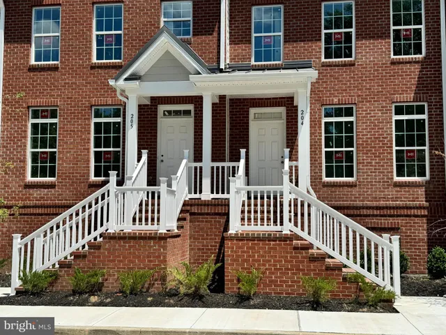a view of a brick house with staircase and wooden floor