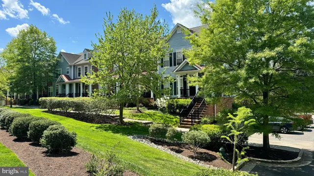 a view of a house with a yard and garden