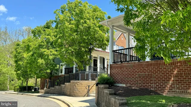 a view of a patio with couches table and chairs and potted plants