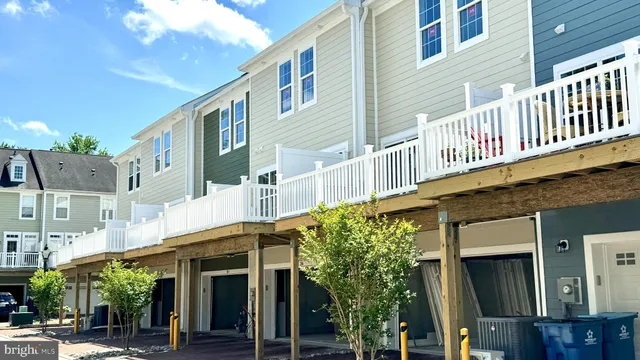 a front view of a building with a garden and plants