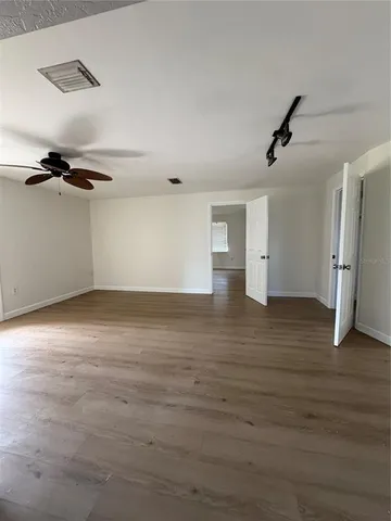 a view of a room with wooden floor