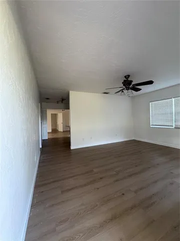a view of a room with wooden floor