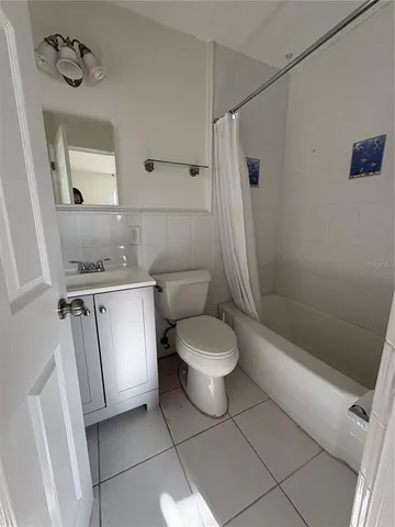 a bathroom with a toilet sink and shower