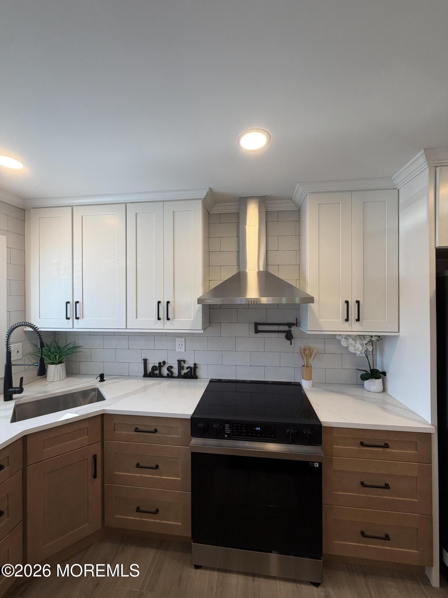 a kitchen with cabinets appliances a sink and a window
