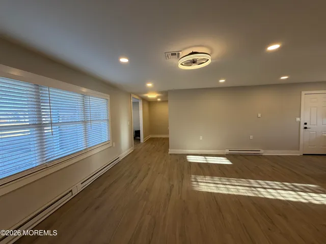 a view of a room with an empty space and a window