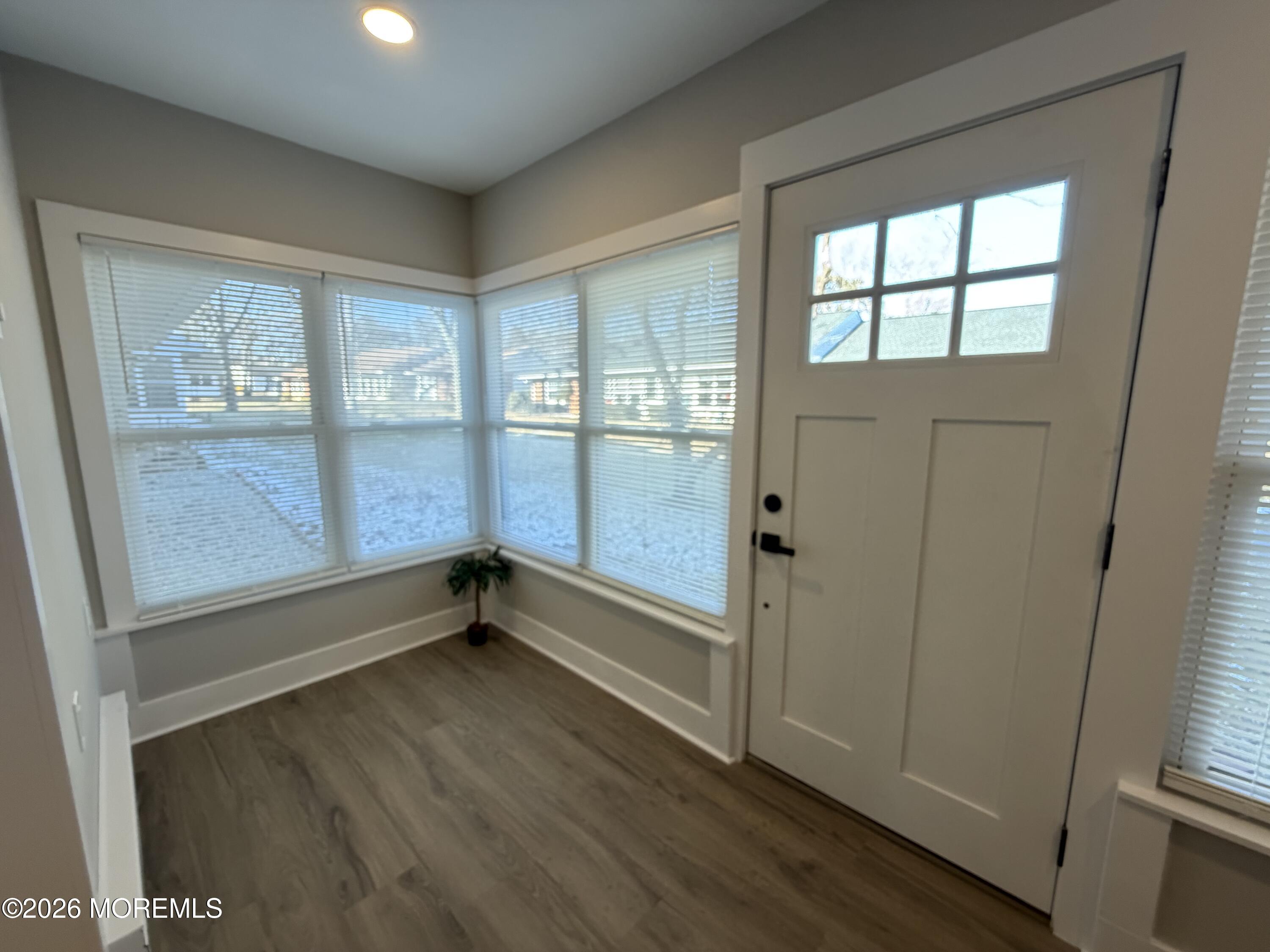 833 B Inverness Court, Unit B Lakewood, NJ 08701 - Photo 15 of 43 an empty room with wooden floor and windows