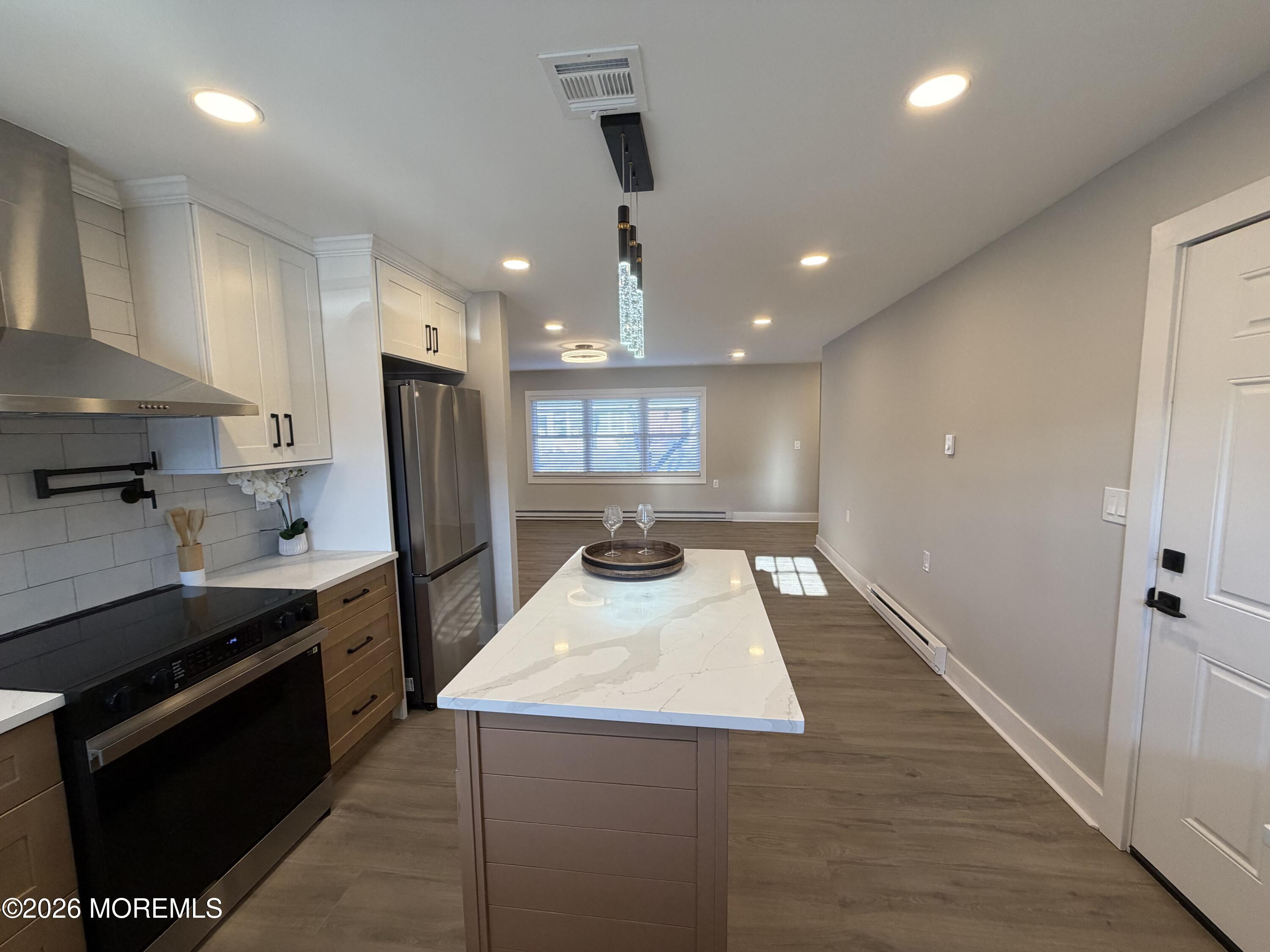 833 B Inverness Court, Unit B Lakewood, NJ 08701 - Photo 2 of 43 a kitchen with kitchen island a counter space a stove a refrigerator and a sink