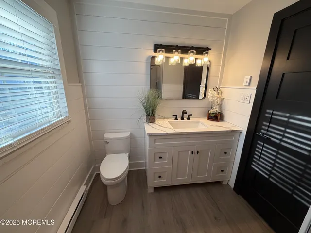 a bathroom with a double vanity sink mirror and toilet