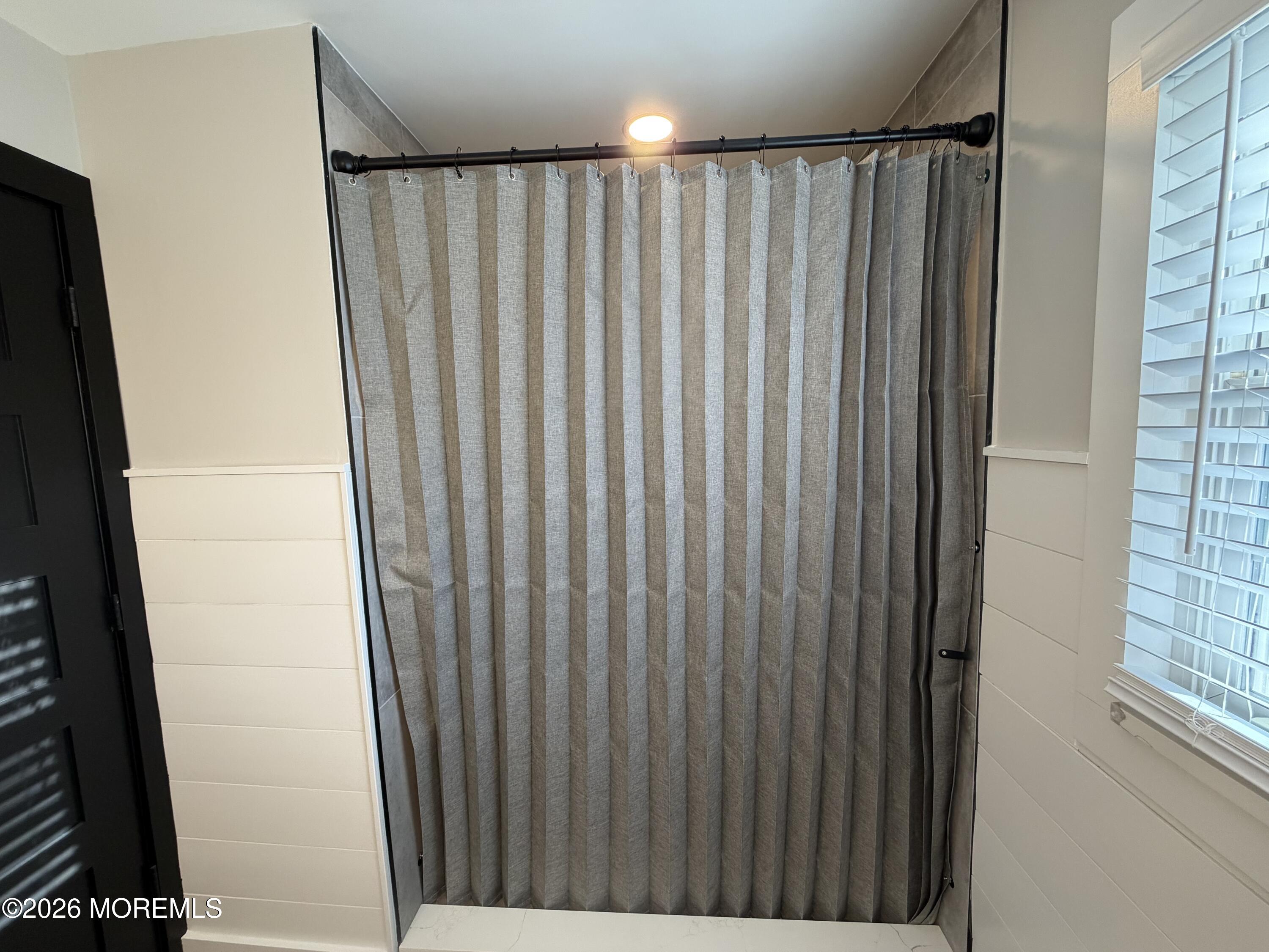 833 B Inverness Court, Unit B Lakewood, NJ 08701 - Photo 36 of 43 a view of a bathroom with shower curtain