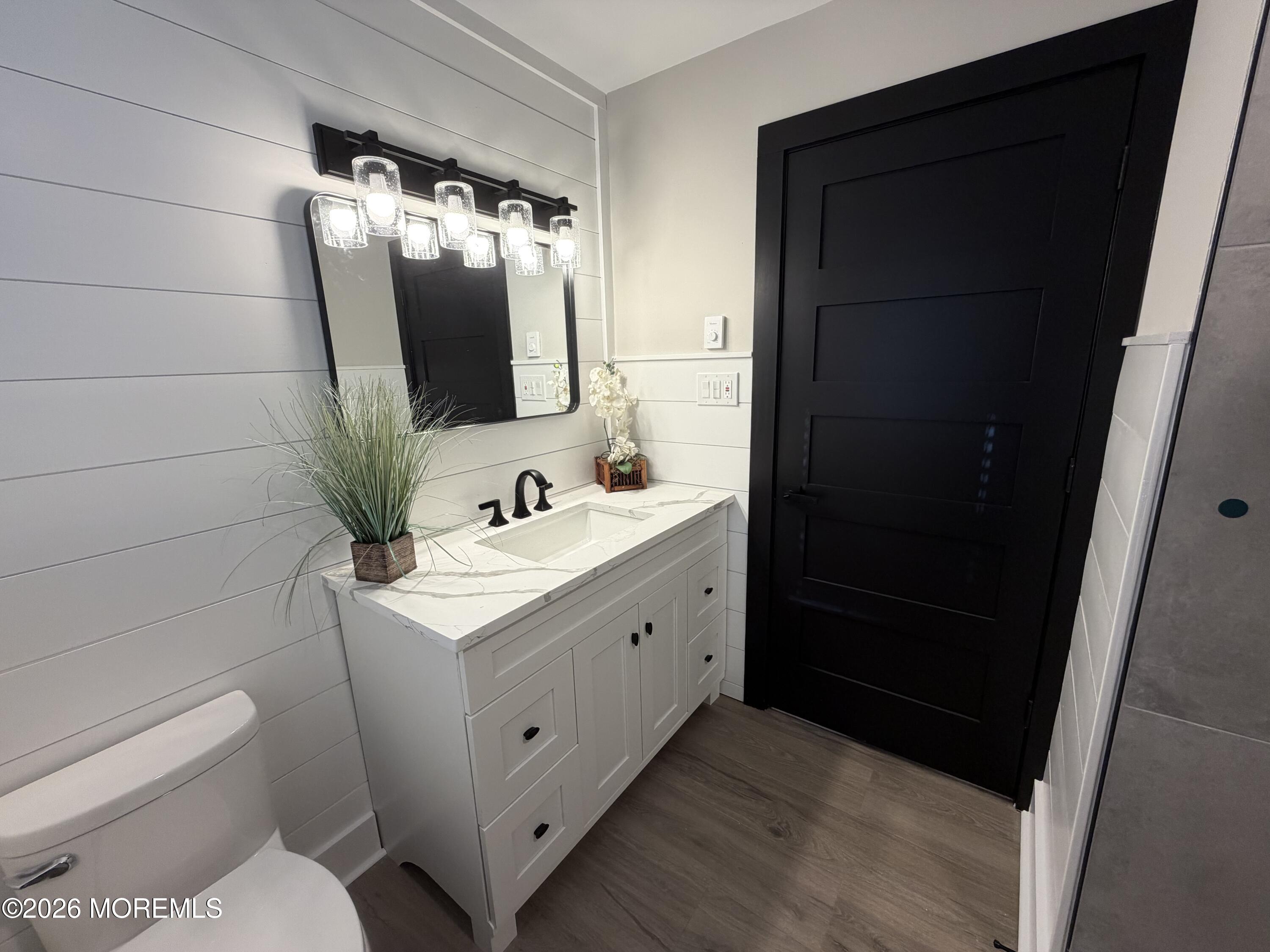 833 B Inverness Court, Unit B Lakewood, NJ 08701 - Photo 37 of 43 a bathroom with a sink toilet and mirror