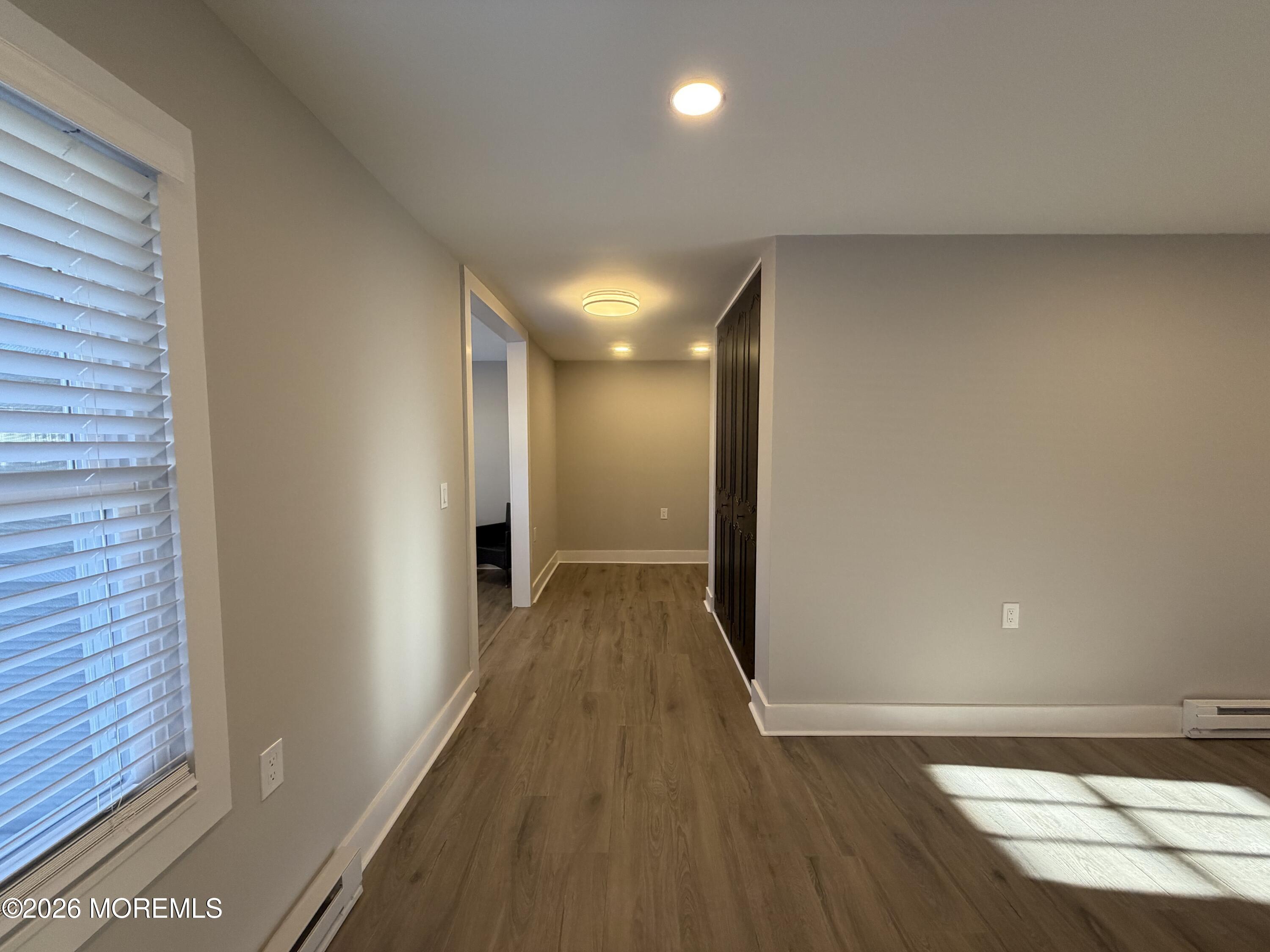 833 B Inverness Court, Unit B Lakewood, NJ 08701 - Photo 8 of 43 a view of hallway with wooden floor