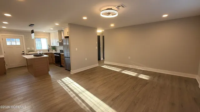 a view of a kitchen with a sink and a refrigerator