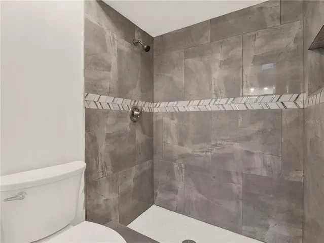 a bathroom with a shower and toilet