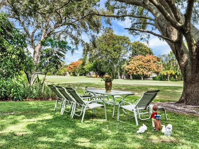 a view of a table and chairs in the garden
