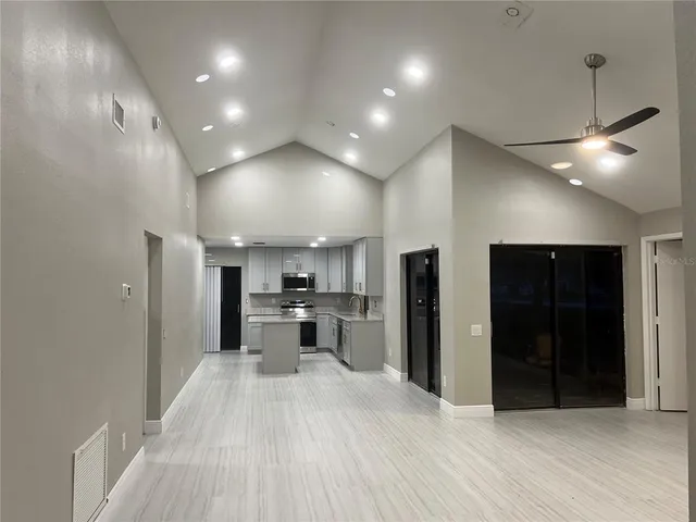 a view of a kitchen with a sink and a refrigerator