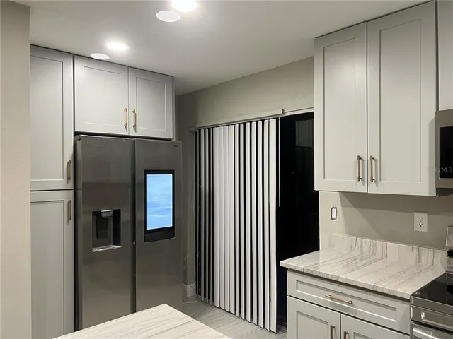 a kitchen with a refrigerator and cabinets