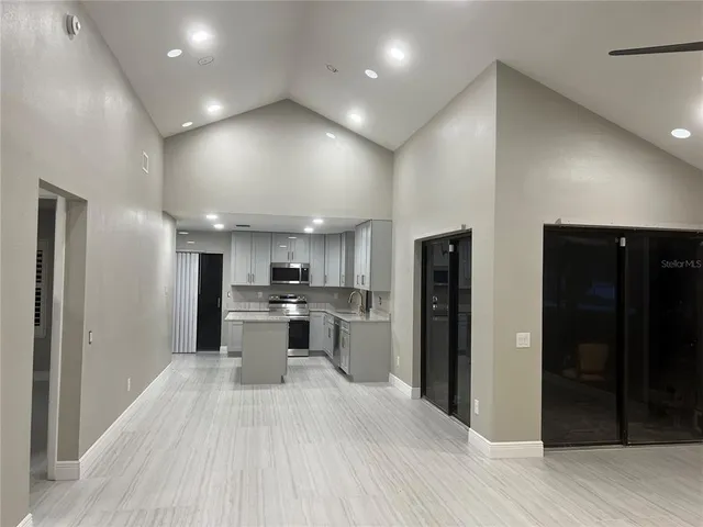 a large kitchen with a large counter top appliances and cabinets