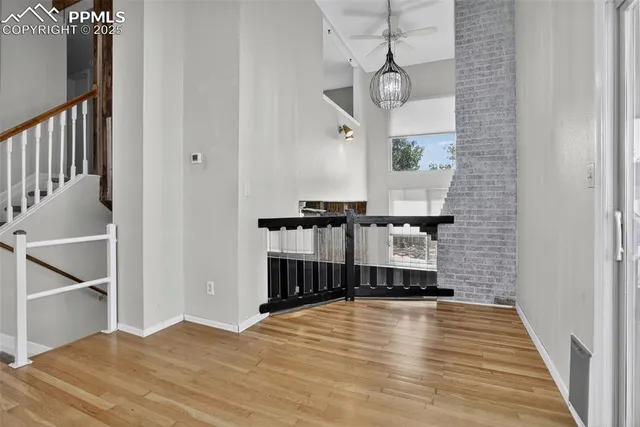 a view of a room with wooden floor and staircase