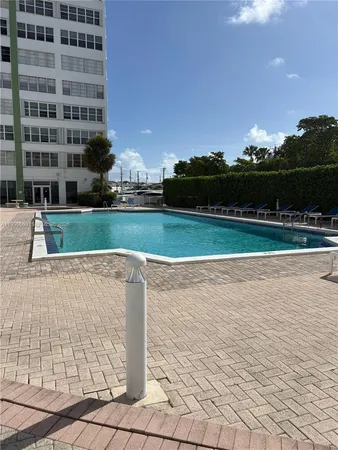 a view of a swimming pool and a yard