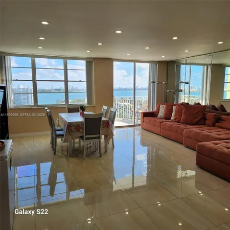 a view of a hallway with furniture and entryway