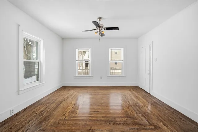 wooden floor in an empty room with a window