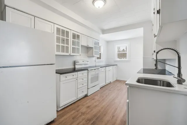 a kitchen with cabinets a sink and appliances