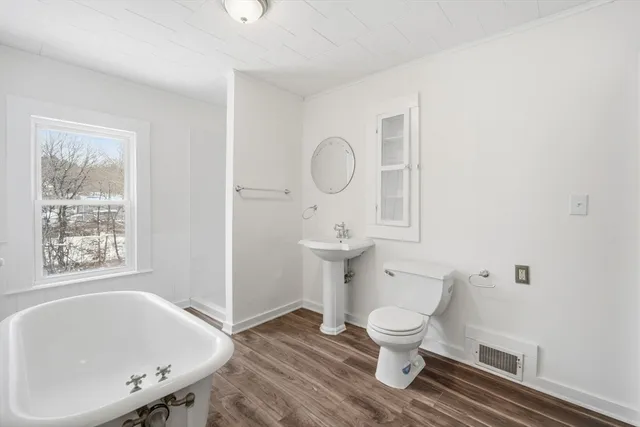 a bathroom with a toilet a sink and a bathtub