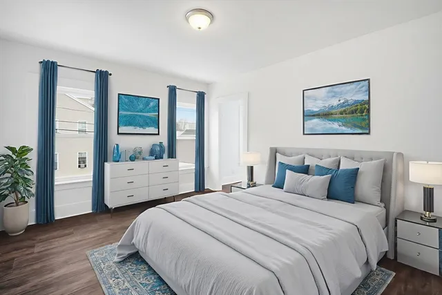 a bedroom with a bed and a large window