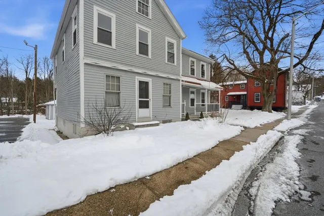 a pathway of a house with a yard covered in snow