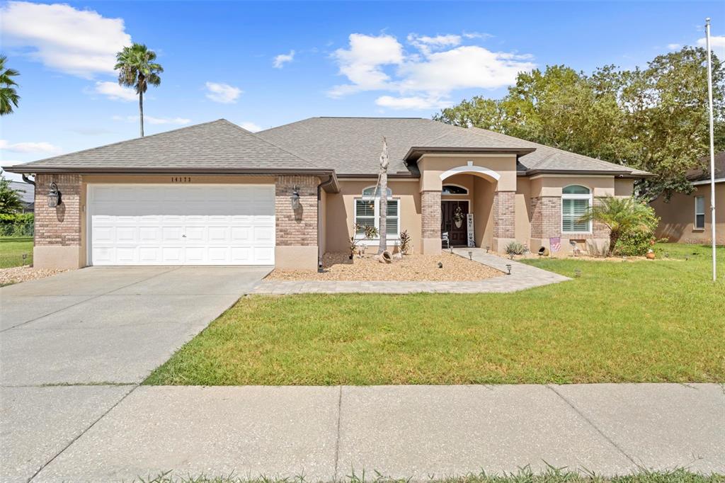 a front view of a house with a yard and garage