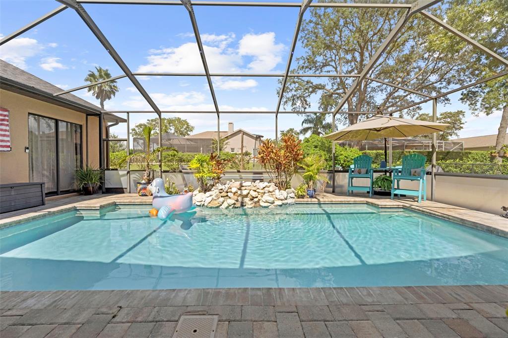 14173 Pullman Drive Spring Hill, FL 34609 - Photo 13 of 77 a view of a swimming pool with a patio