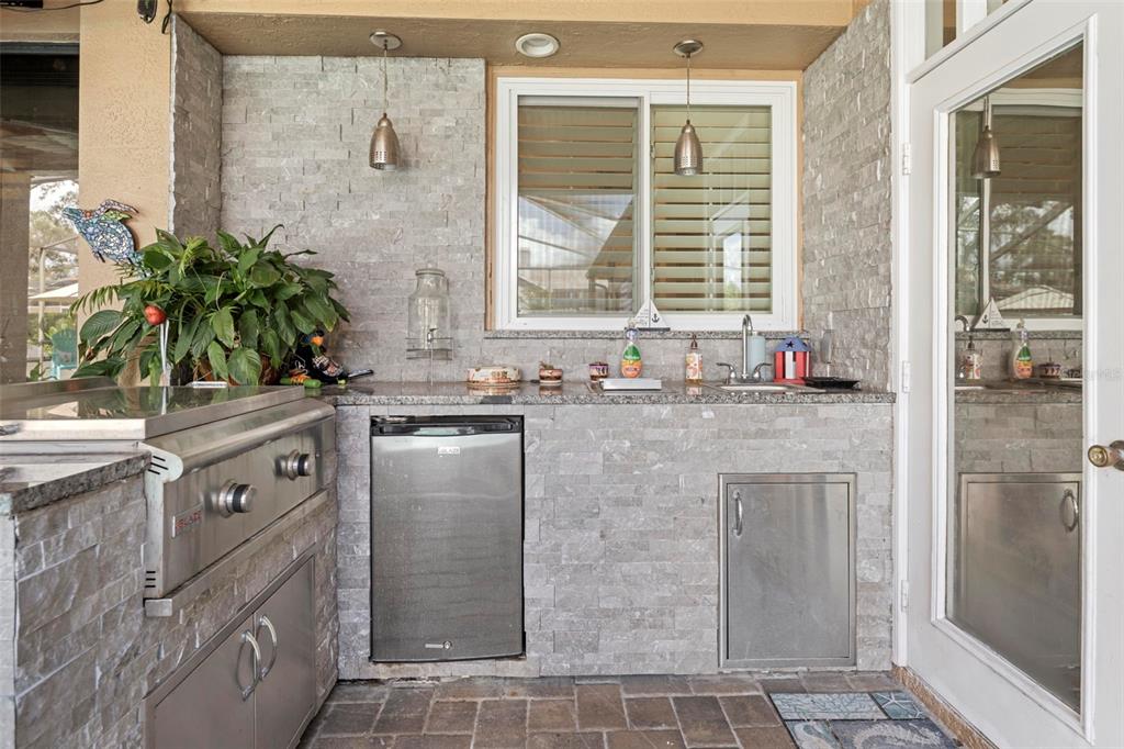 14173 Pullman Drive Spring Hill, FL 34609 - Photo 18 of 77 a bathroom with a granite countertop sink a large mirror and a shower