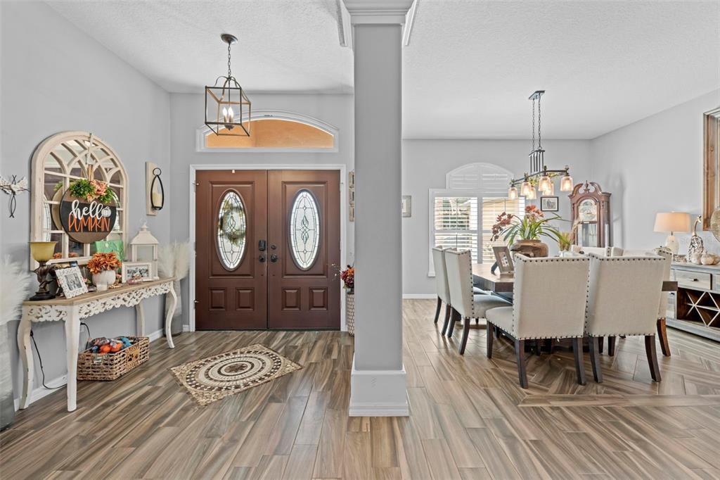 14173 Pullman Drive Spring Hill, FL 34609 - Photo 26 of 77 a view of a dining room with furniture window and wooden floor