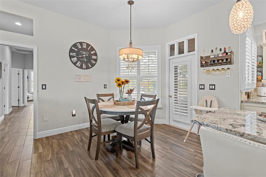 14173 Pullman Drive Spring Hill, FL 34609 - Photo 41 of 77 a view of a dining room with furniture window and wooden floor